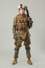 Soldier in camouflage holding rifle