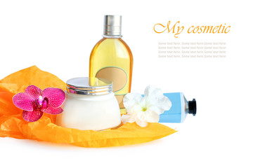 cosmetics set with orchid and petunia flowers on white background. composition