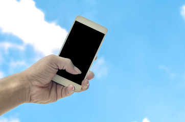 hand holding smartphone isolated on sky background
