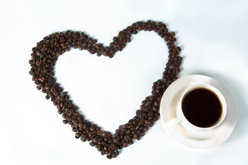 Coffee beans in the form of hearts with a cup