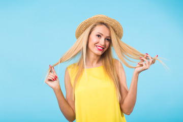 Portrait of smiling blonde woman in fashionable look on blue background. Style, fashion, summer and people concept