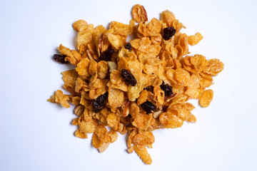 Corn flakes caramel, currant, cashew nut on white background. Close up.