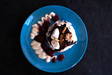 Cake on a blue plate on a black background