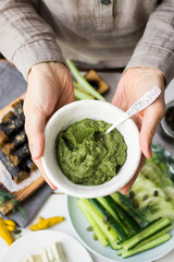 Italian pesto green dip sauce with spinach, walnuts, garlic, olive oil. Homemade, organic farm product. Raw vegan vegetarian healthy food