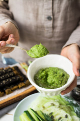 Italian pesto green dip sauce with spinach, walnuts, garlic, olive oil. Homemade, organic farm product. Raw vegan vegetarian healthy food