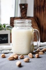 Seeds, walnuts, almond raw vegan milk with banana. Healthy food concept.