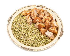 Group of jaggery with Coriander Seeds also Know as Gur, Goor or Gud isolated on White Background