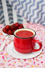 Strawberry smoothie and puree in red cup. Raw and vegan breakfast. Healthy food.