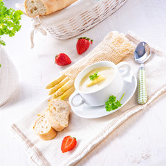 asparagus cream soup with capers and fresh baguette