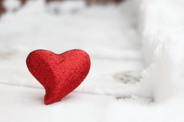 Fototapeta premium Red glitter heart in the winter snow