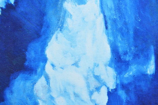 White and blue watercolor paints are mixed on canvas. © xzgorik