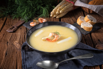delicious asparagus cream soup with prawns and fresh dill