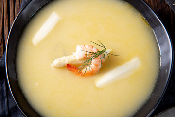 delicious asparagus cream soup with prawns and fresh dill