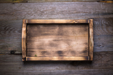 Handmade burned box on a wooden rustic texture for background. Rough weathered wooden board. Toned