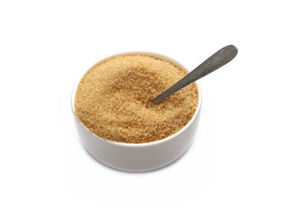 Brown cane sugar in porcelain bowl with metal spoon isolated on white background, sugarcane texture