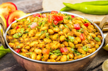Indian Cuisine Rajma Masala or Rajmah is a South Asian Vegetarian Dish Consisting of White Kidney Beans in a thick gravy with many Indian whole spices and usually served with Chapati and food