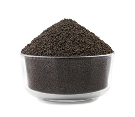 Aromatic Black Tea Loose or Dried Tea Leaves in Glass Bowl  isolated on White Background