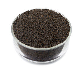 Aromatic Black Tea Loose or Dried Tea Leaves in Glass Bowl  isolated on White Background