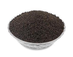 Aromatic Black Tea Loose or Dried Tea Leaves in Glass Bowl isolated on White Background