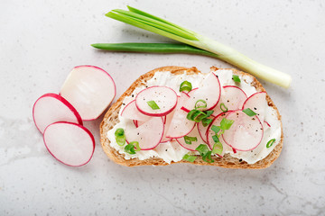 Sandwich with cream cheese, radish and green onions.