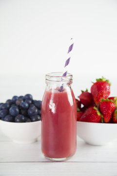 Berry Fruit Smoothy on a White Wood Table