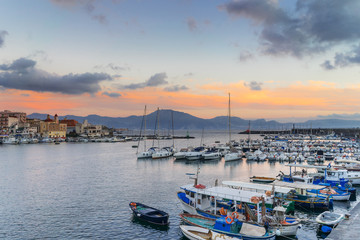 Fototapeta na wymiar Sunset in Torre del Greco port near Naples, on background Sorrento peninsula