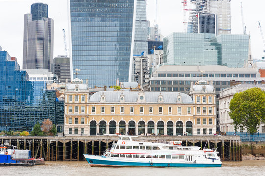 Financial district of London modern building and boat on Thames river, England