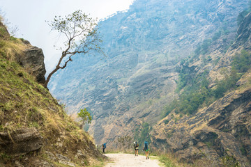 Fototapeta premium Tourists on a mountain road in the Himalayas.