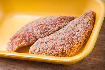 Preparing chicken breast fillets with breadcrumbs