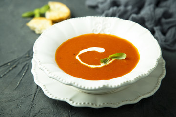 Homemade tomato soup with cream and fresh basil
