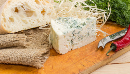 Blue cheese and ciabatta on the wooden cutting board