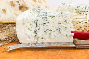 Blue cheese closeup against of ciabatta and knife