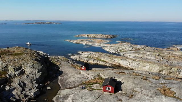 Aerial footage of red cabins on an island in the Stockholm archipelago