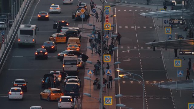 MOSCOW, RUSSIA - AUGUST 07, 2017: Intense traffic at the exit from Sheremetyevo Airport, evening view. People waiting for transport and taking taxi