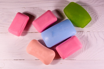 Pieces of the soap on wooden table. Top view