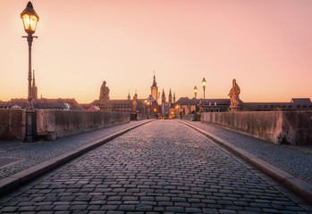 Scenic sunrise morning view of the Old Main Bridge over the Main river in the Old Town of Wurzburg,...