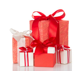 Many different gift boxes decorated with ribbons and bow isolated on white