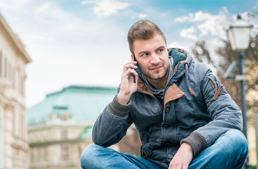 Young man on phone calling. Guy talking on smartphone