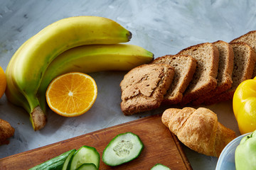 Ingredients for school lunch and plastic container on the table, close-up, selective focus