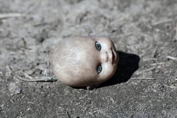 The terrible head from a doll. Horror background with head from the doll.