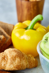 Ingredients for school lunch and plastic container on the table, close-up, selective focus