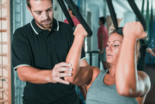 Personal trainer with woman in the gym