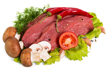 Fresh veal tenderloin, mushrooms, tomato and spices, on lettuce leaves isolated on white
