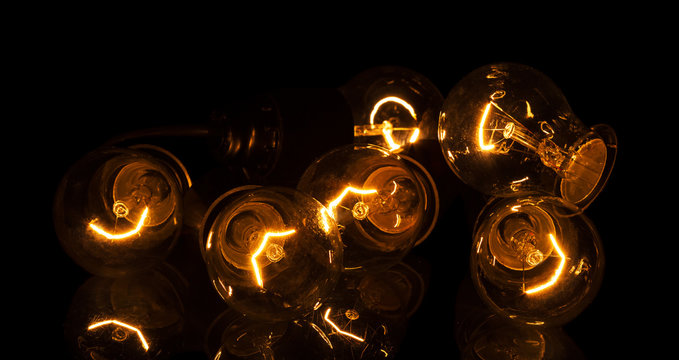 Incandescent lamps in operation, isolated on black