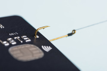 Credit card on fishing hook fraud data leak money stealing phishing concept
