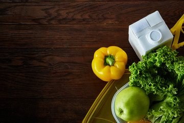 Healthy lunch prepared in small plastic container, top view, close-up.