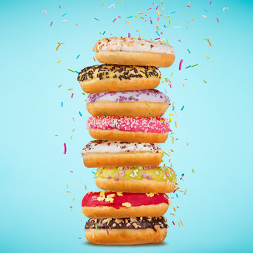 Tasty doughnuts on pastel blue background.