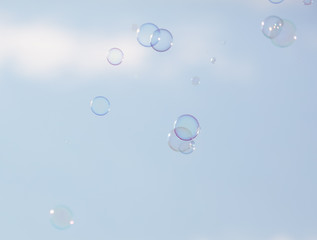 Soap bubbles in flight against the sky