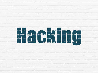 Obraz premium Safety concept: Painted blue text Hacking on White Brick wall background
