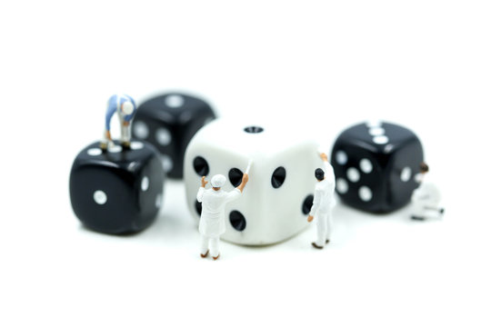 Miniature people : painter man painting a dices with paint roller